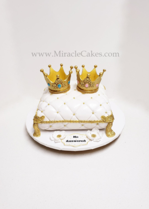 Pillow cake with two crown toppers for twins baby shower