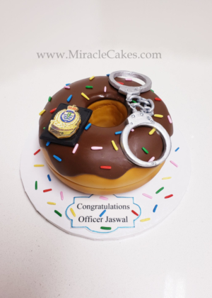 Donut cake with edible hand cuffs for a officer who is graduating