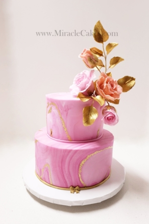Pink marble designed cake with sugar flowers