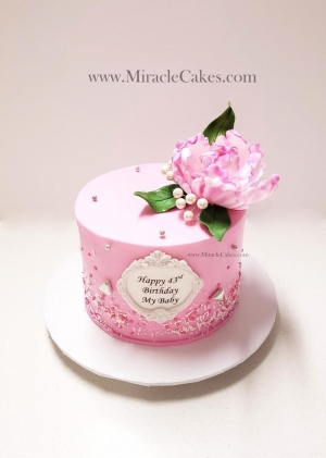 Sparkly birthday cake with a sugar flower 