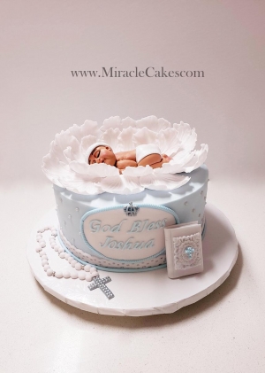 Christening cake with a handcrafted baby topper. 