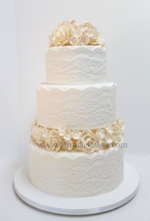 Off white wedding cake with Ivory color flowers